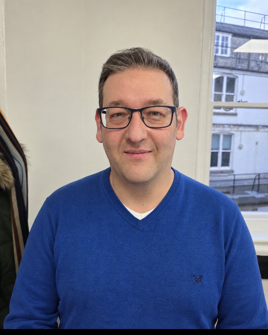 Marco, founder and Italian teacher at ItalianoQuick, smiling in a blue jumper